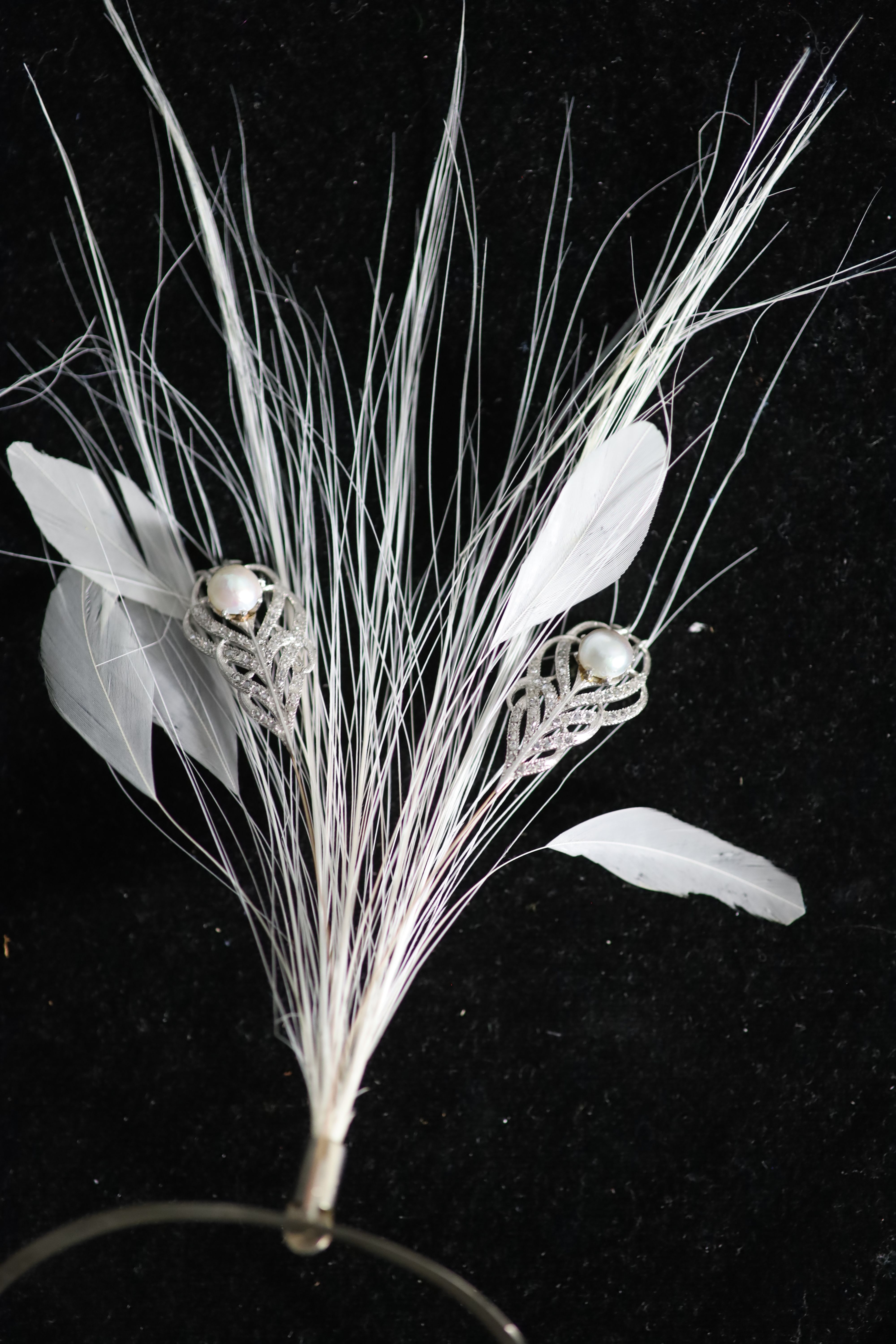 An early 20th century, continental gold and silver?, split pearl and diamond chip set aigrette, in later fitted case,